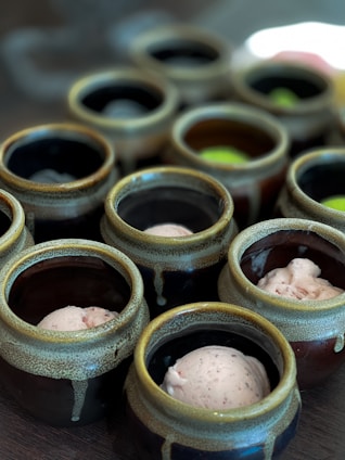 Close-up of colorful artisanal ice creams in rustic bowls on a wooden table