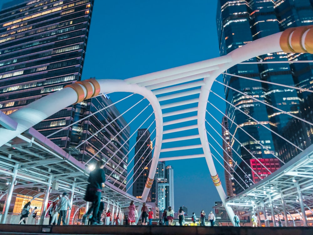 people walking on a bridge during night time