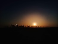 A cinematic shot of a sunset over a city skyline, hinting at the setting of an upcoming film.