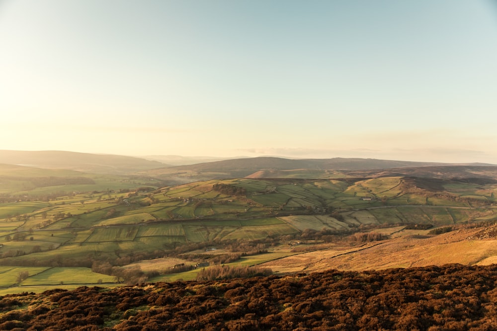 brown and green mountains under white sky during daytime