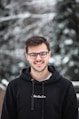 man in black hoodie wearing black framed eyeglasses