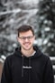 man in black hoodie wearing black framed eyeglasses