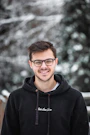 man in black hoodie wearing black framed eyeglasses