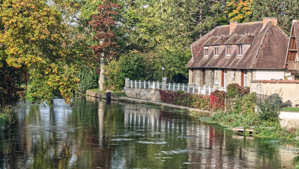 brown wooden house near river