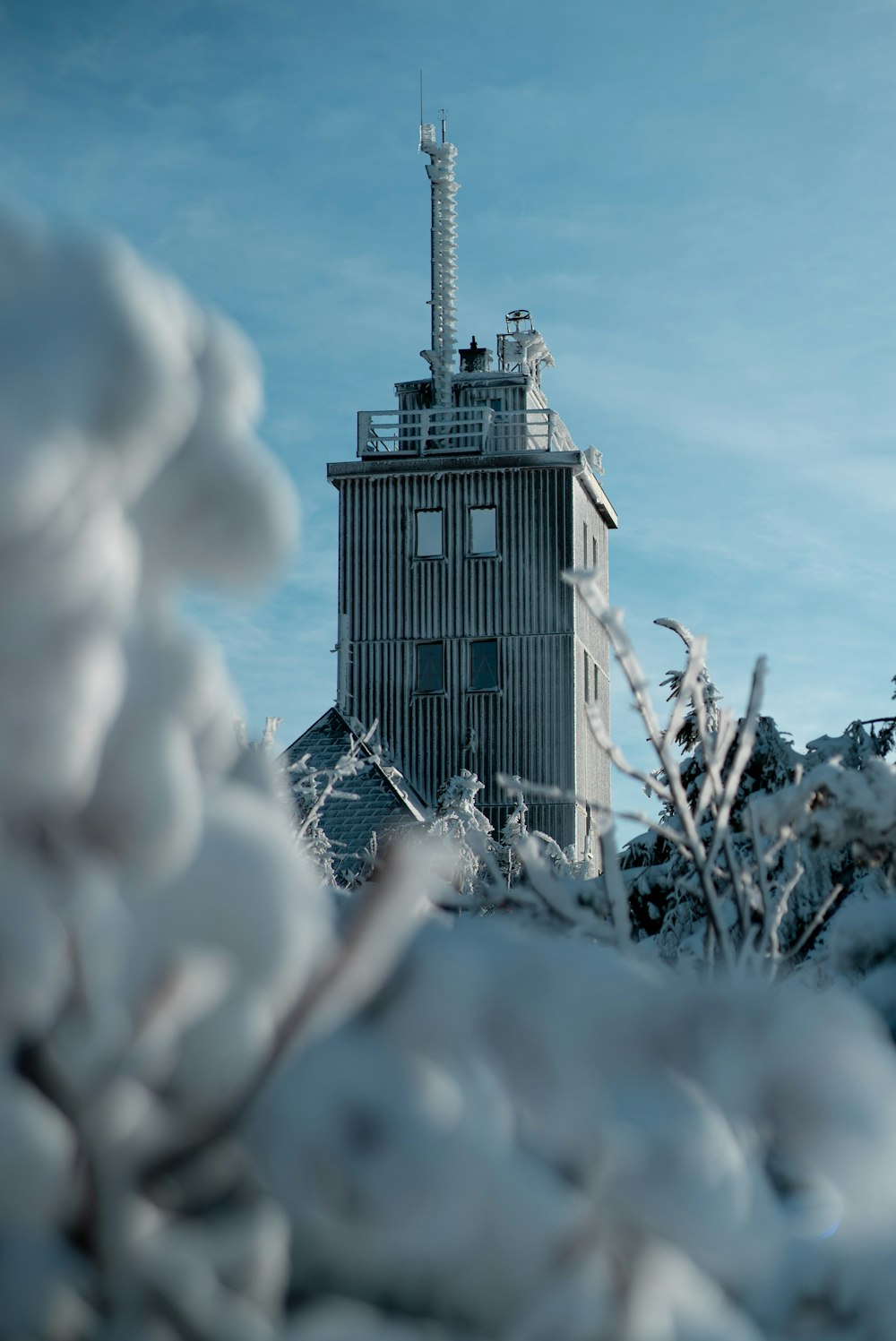 white and black house on snow covered ground during daytime