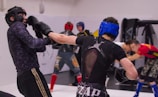 Group of athletes sparring during a boxing session.