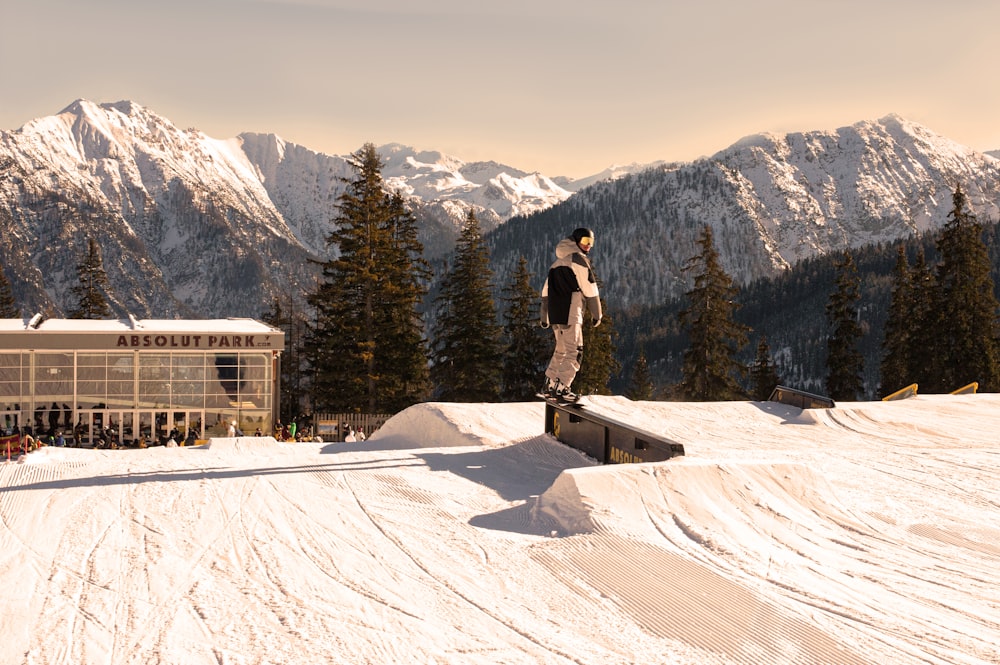 man in black jacket and black pants standing on snow covered ground during daytime