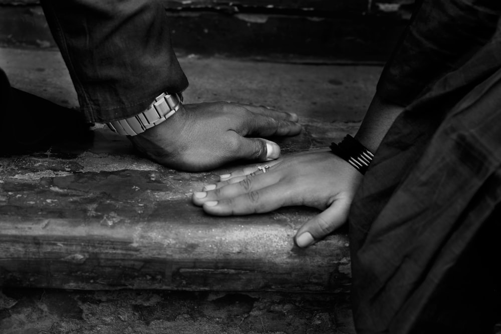 grayscale photo of person wearing silver link bracelet watch