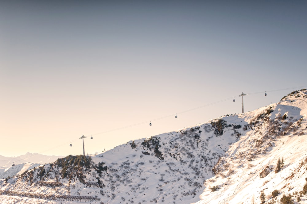 cable cars over snow covered mountain