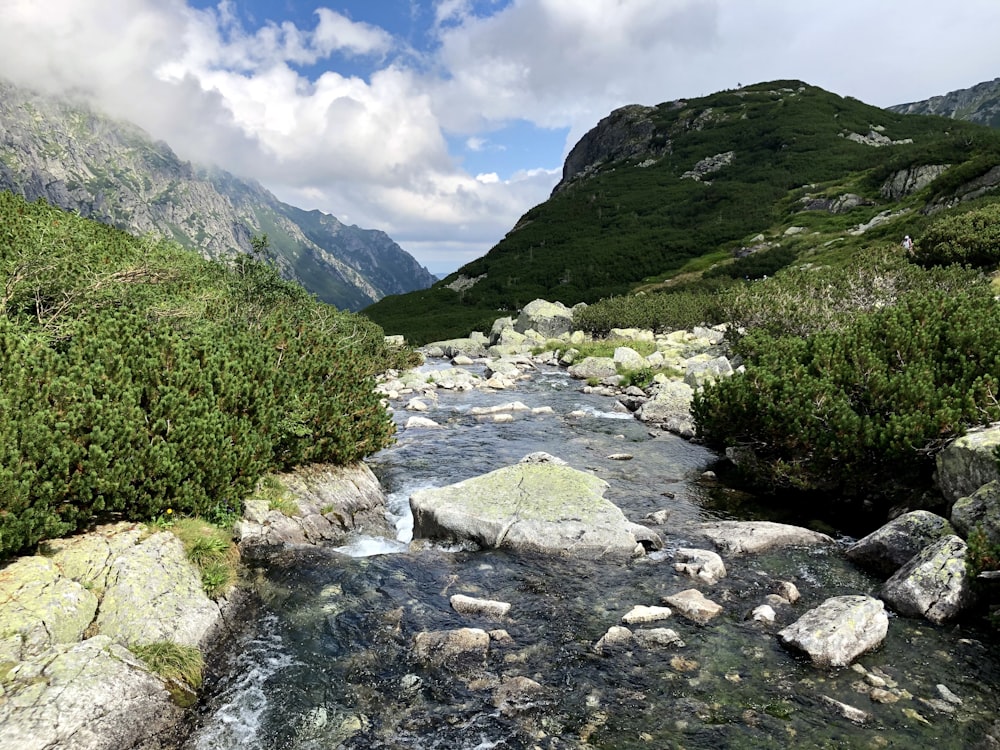 green mountains under blue sky and white clouds during daytime