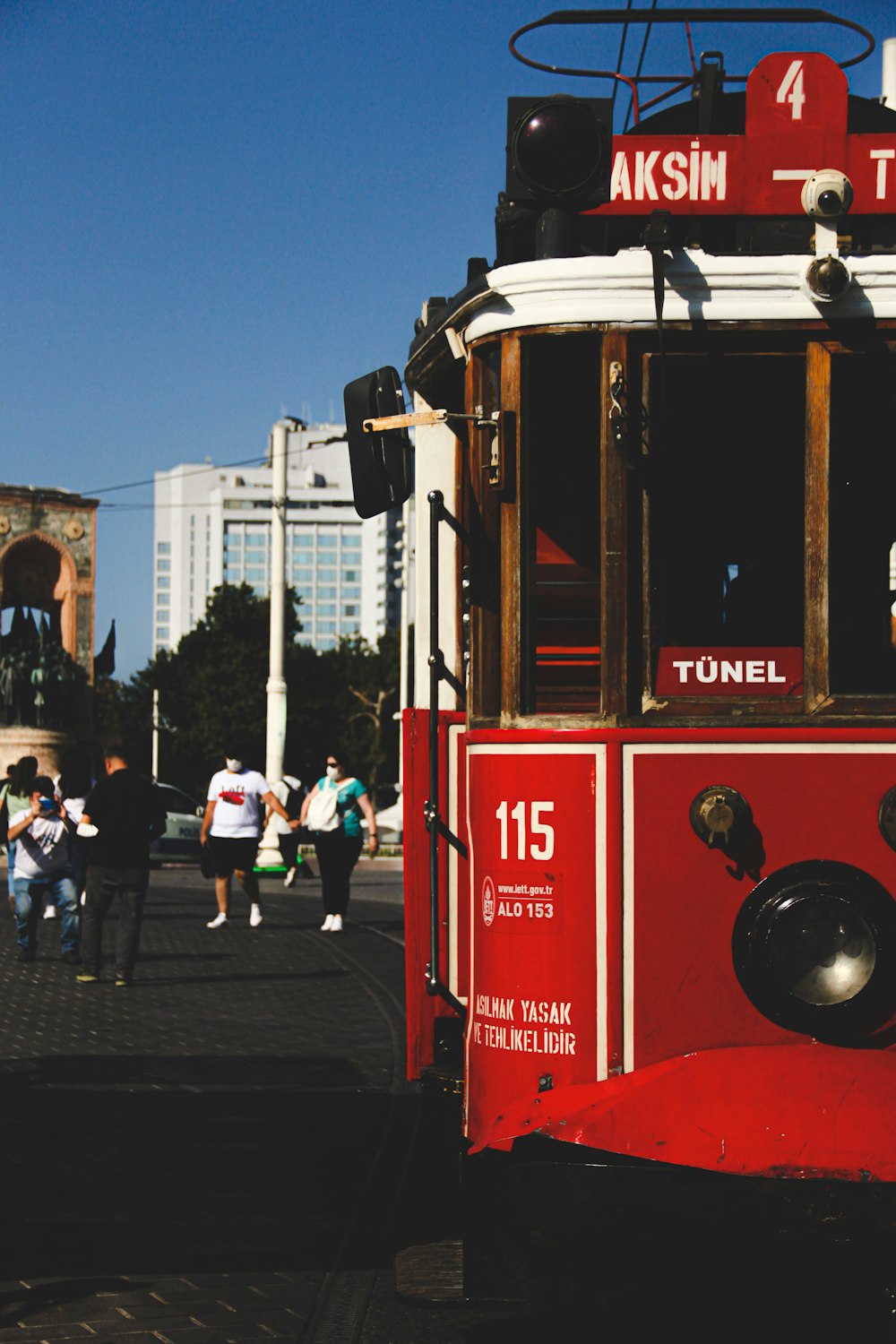 red and white tram on road during daytime