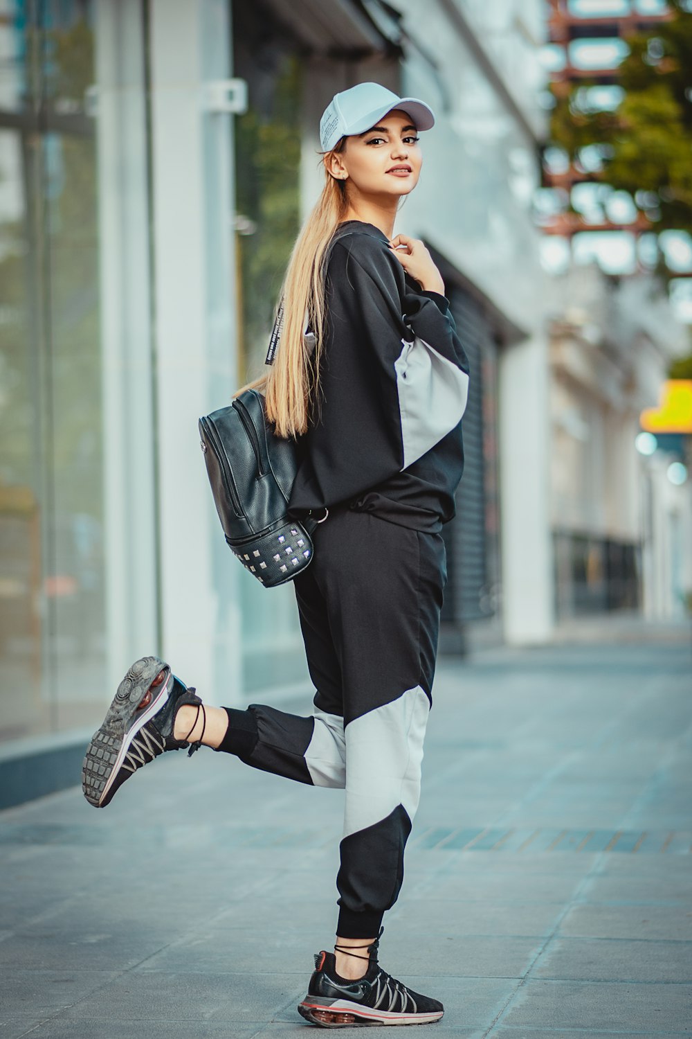 woman in black leather jacket and black pants wearing black leather boots