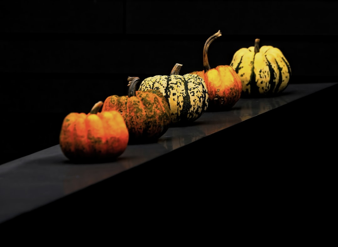orange pumpkins on black wooden table