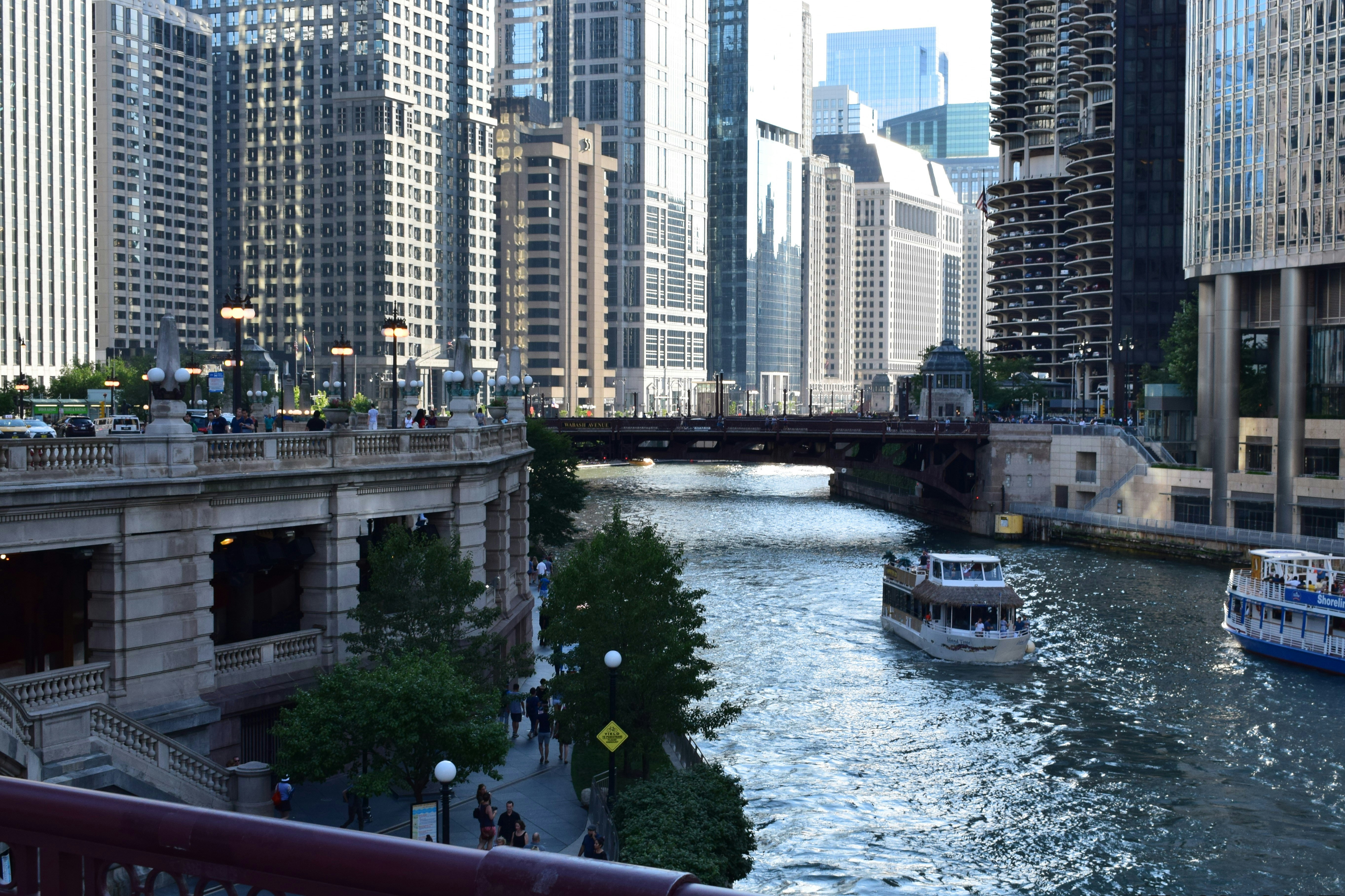 of the Chicago Riverwalk with cafes and people. - apartment buildings downtown chicago
