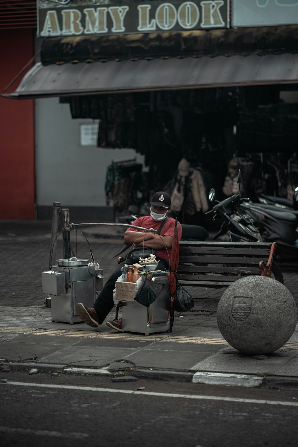 Homme en veste rouge assis sur une chaise en acier noir