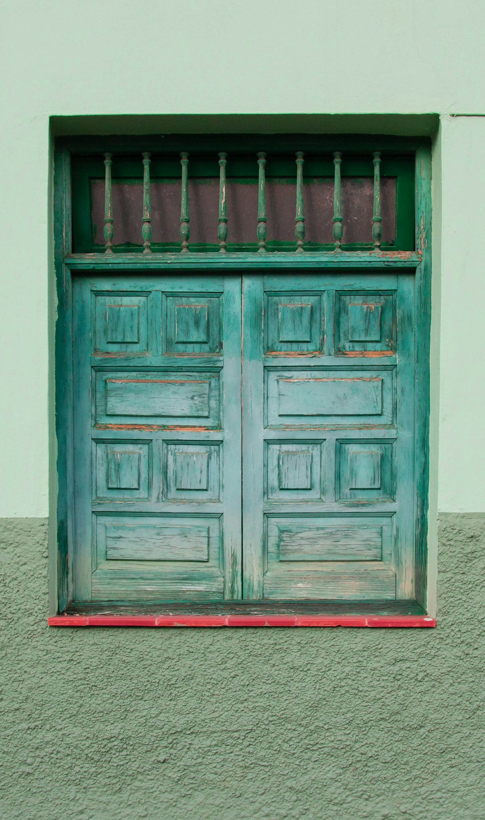 brown wooden door on white wall