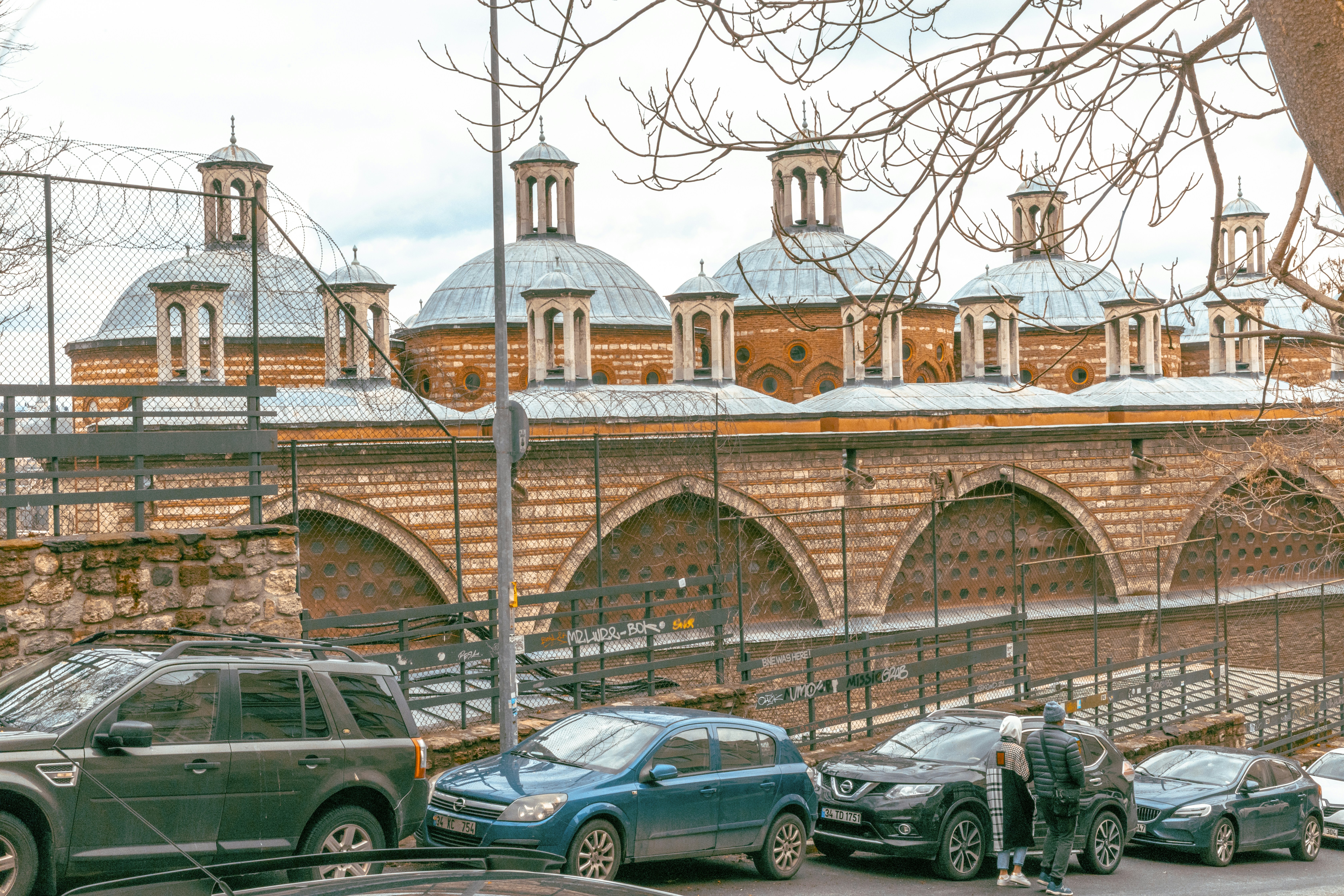 cars parked near brown concrete building during daytime