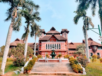 brown and white wooden house surrounded by green trees during daytime