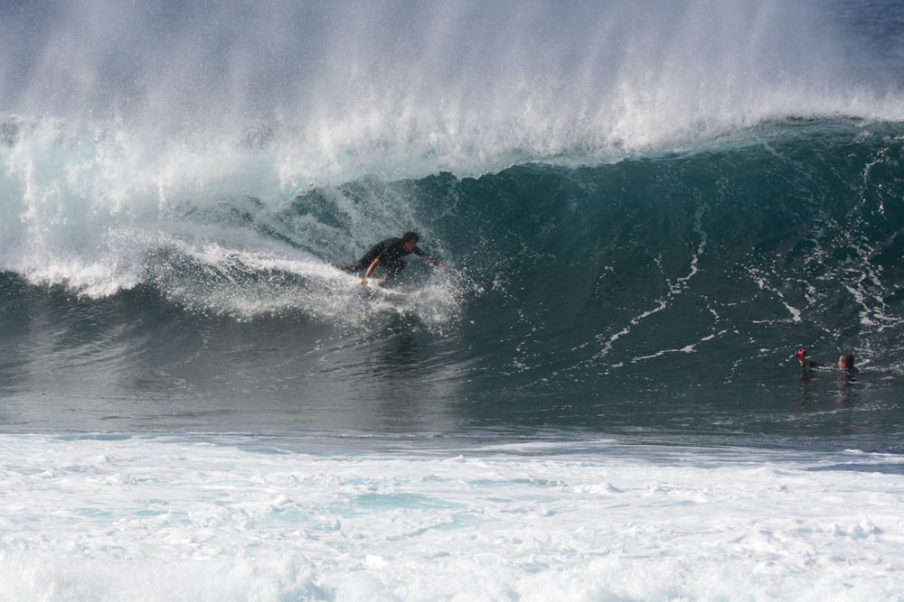 man surfing on sea waves during daytime