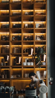 A serene coffee shop setting with a barista at work behind the counter.