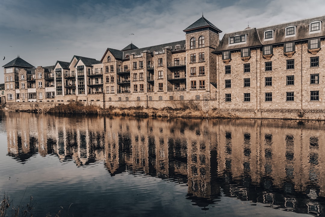 brown concrete building near body of water during daytime