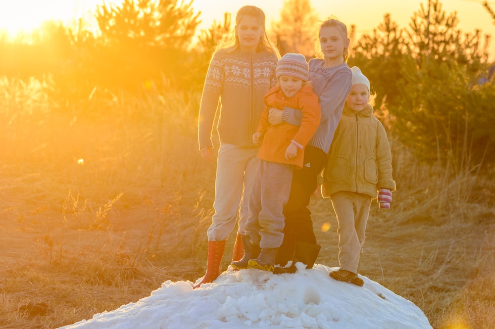 man and woman standing on snow covered ground during daytime