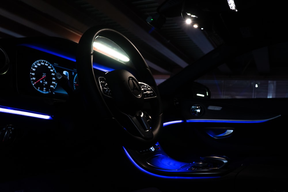 the interior of a car is lit up with blue lights