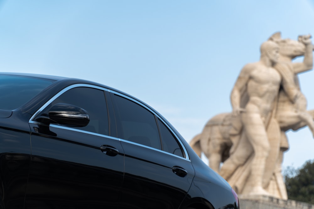 black car near brown rock formation during daytime