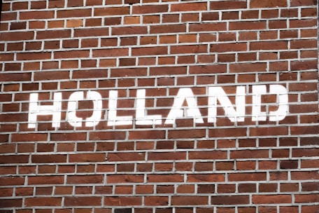 a brick wall with a street sign painted on it