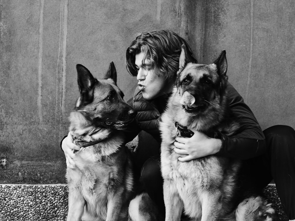 grayscale photo of man and woman with dog