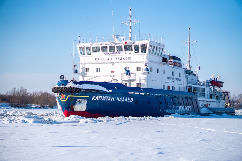 blue and red ship on sea during daytime