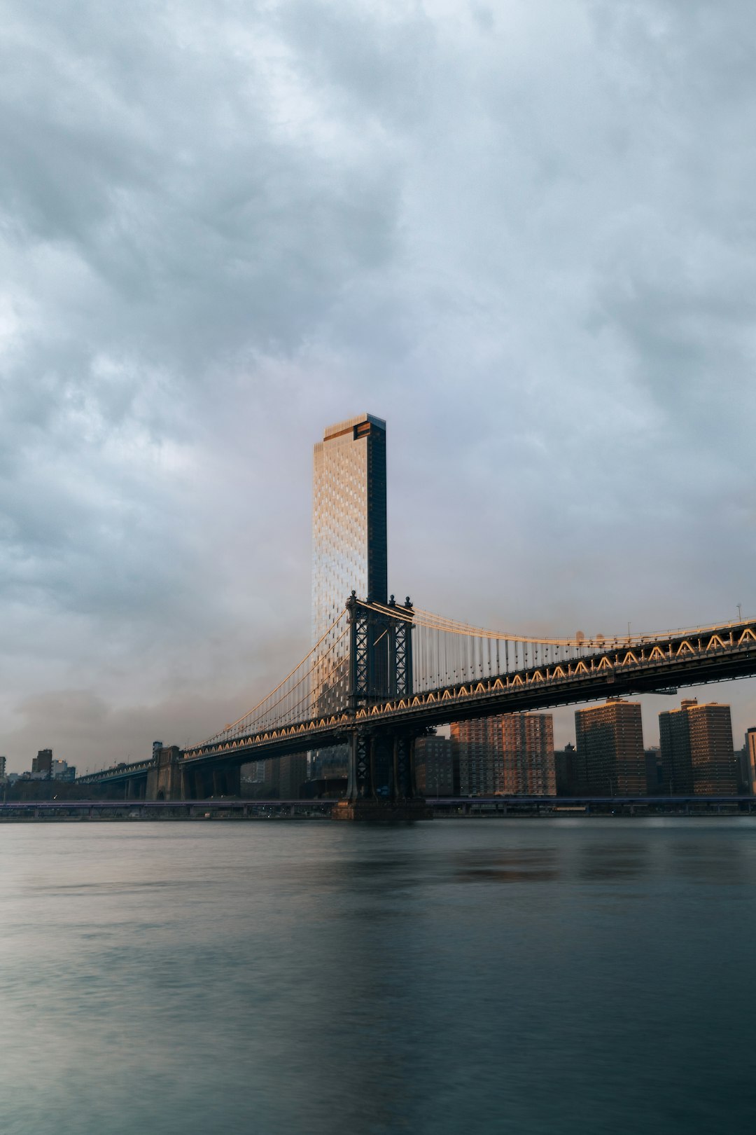 brown bridge under cloudy sky during daytime