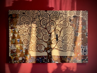 A bold, expressive painting of intertwined tree branches against a muted background.