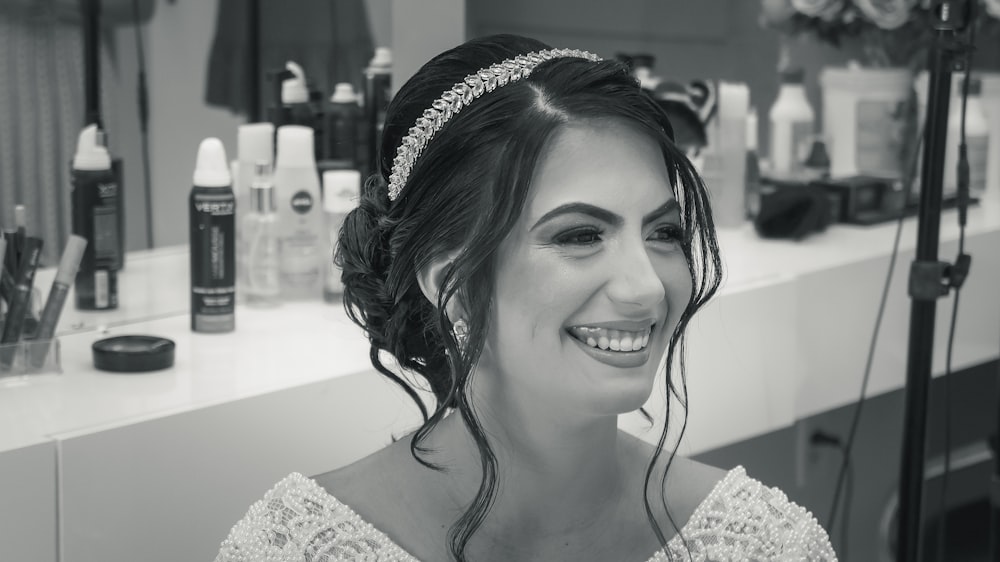 woman in white lace top smiling