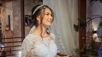 woman in white floral lace dress wearing black and white floral headband