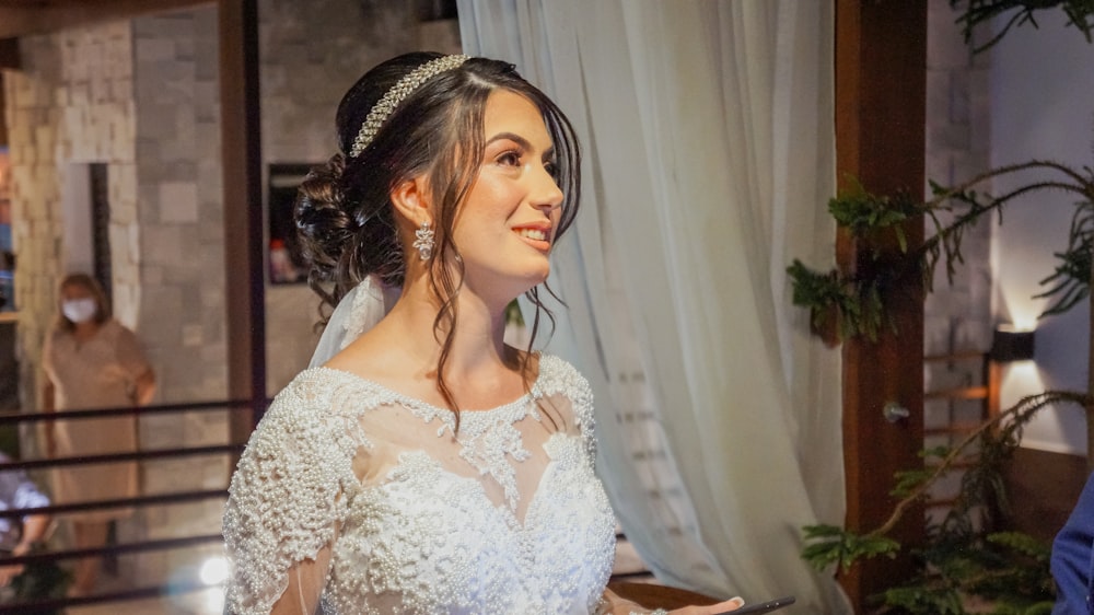 woman in white floral lace dress wearing black and white floral headband