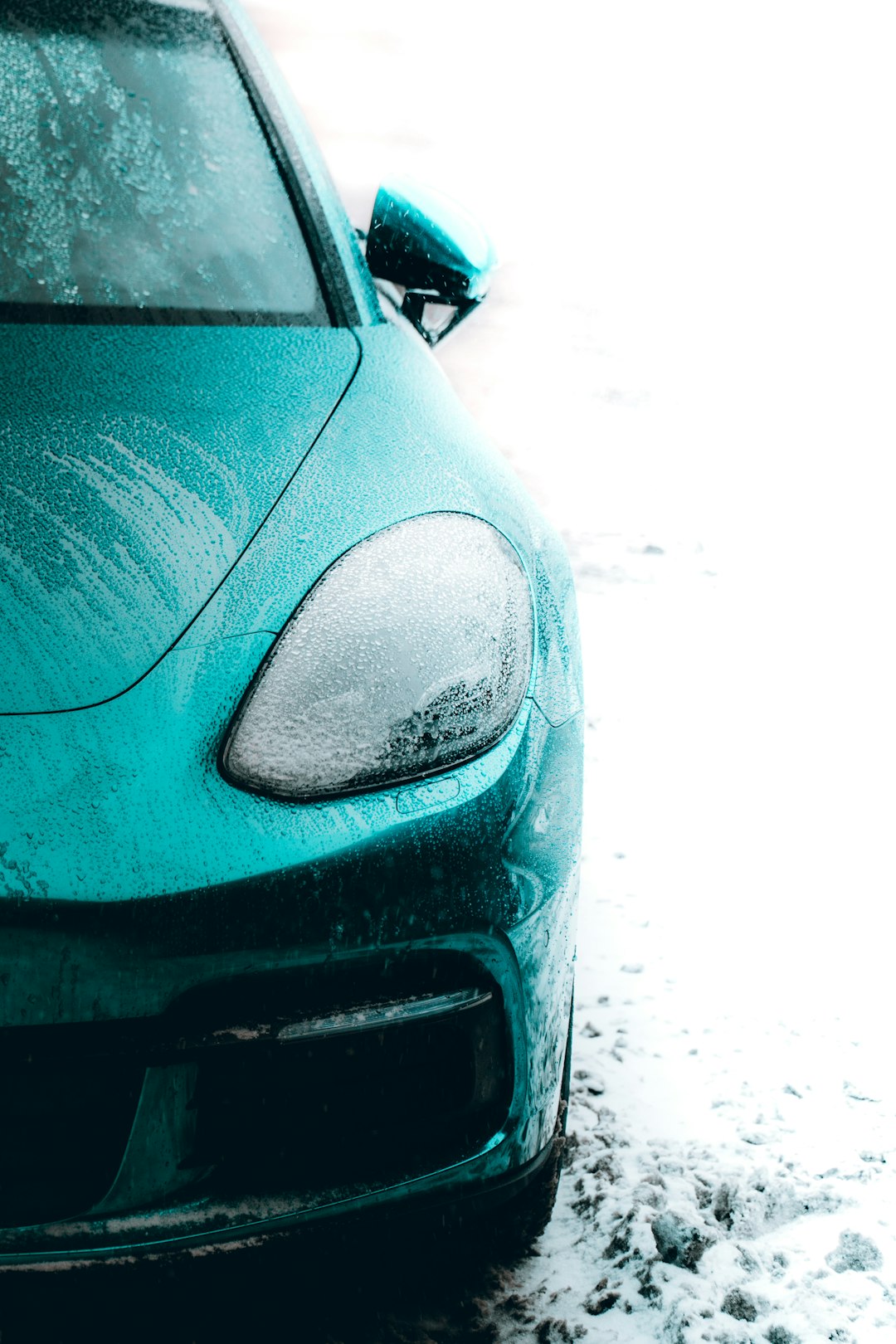 blue car on snow covered ground during daytime