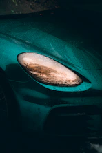 black car side mirror with water droplets