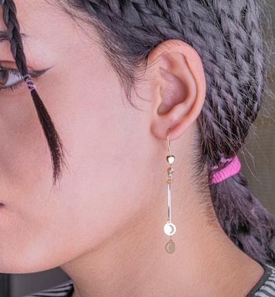 woman wearing black framed eyeglasses and silver stud earring