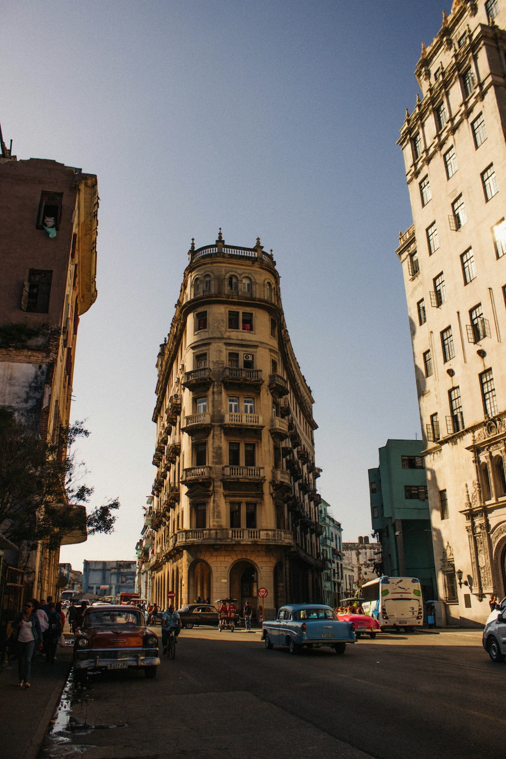 cars parked in front of brown concrete building during daytime