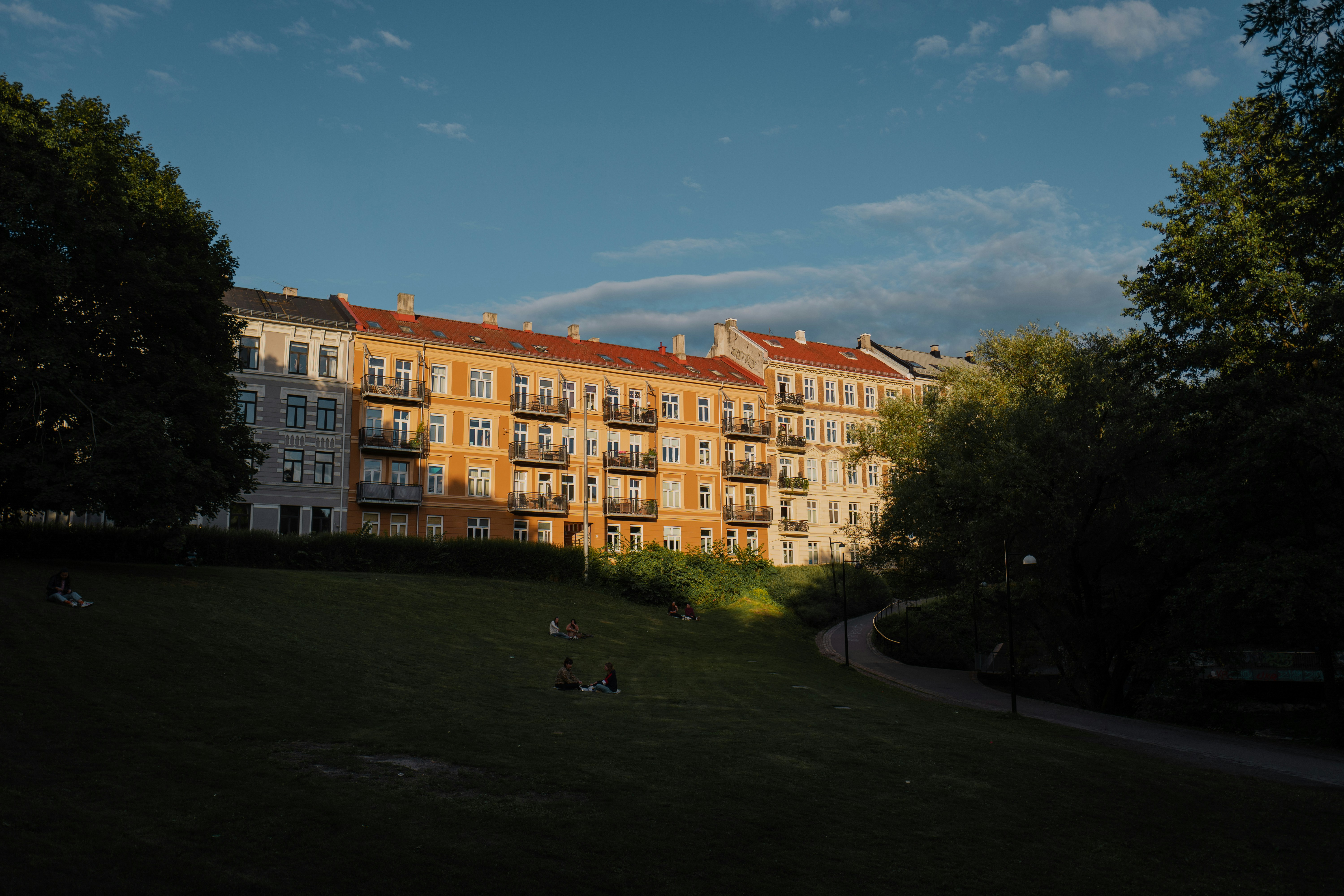 people walking on green grass field near brown concrete building during daytime, 