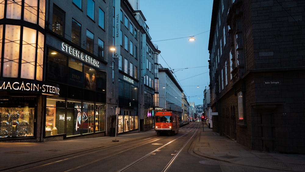 red and white tram on road near building during daytime