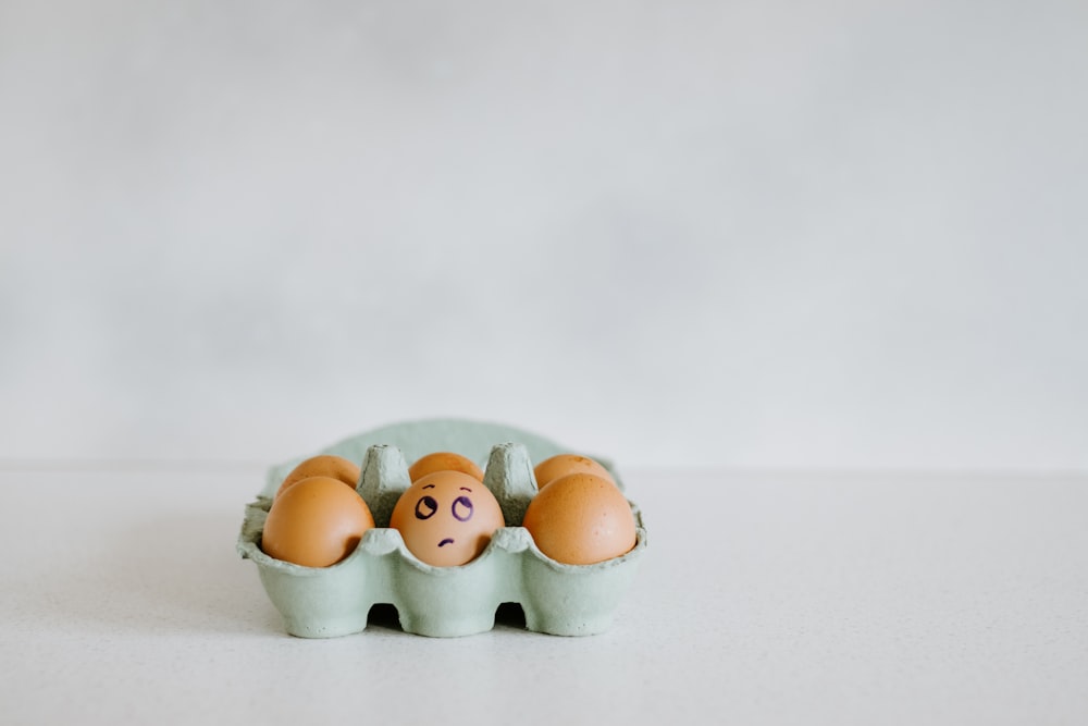 brown and white eggs on white tray