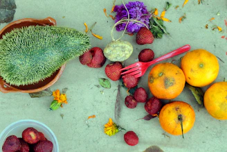 strawberries and green cactus on red plastic container