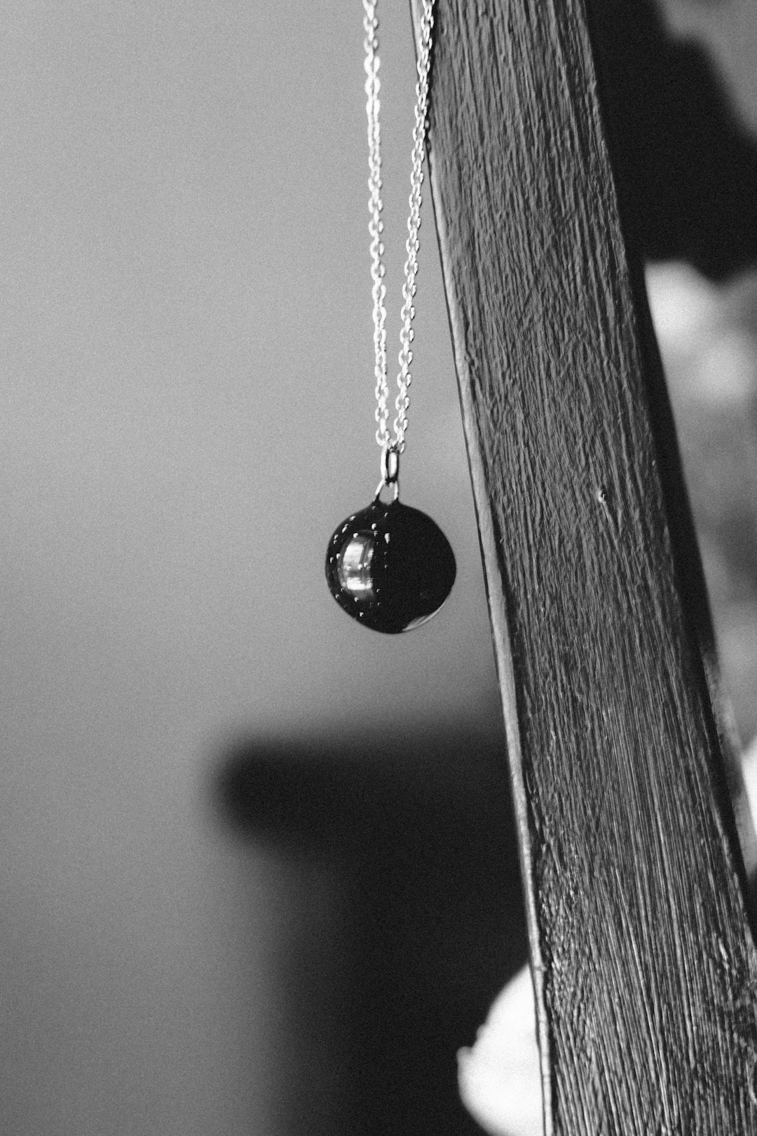 silver heart pendant necklace in grayscale photography