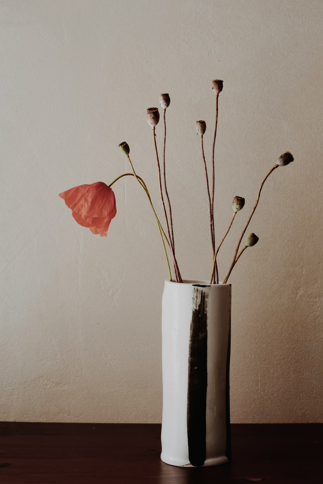 red flower in white ceramic vase