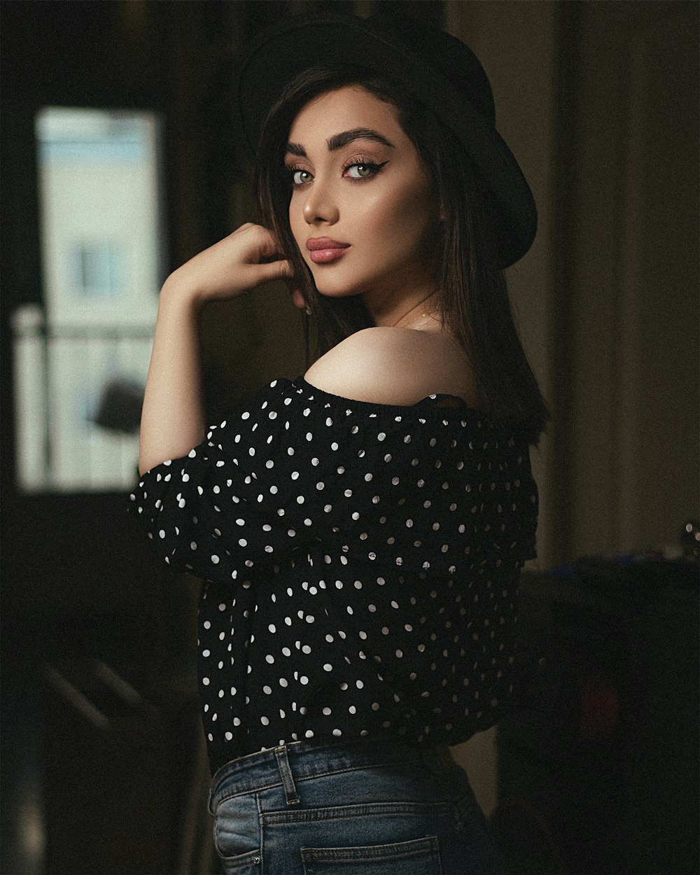 woman in black and white polka dot off shoulder shirt