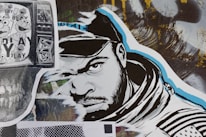 A stylized street art collage features a monochrome illustration of a man’s face wearing a hood. The artwork incorporates bold black and white lines with blue accents. To the left, a black and white print displaying cartoon characters overlaid on a TV screen adds a nostalgic element. A variety of textures and abstract backgrounds are present, contributing to a dynamic urban aesthetic.