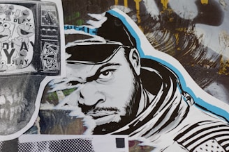 A stylized street art collage features a monochrome illustration of a man’s face wearing a hood. The artwork incorporates bold black and white lines with blue accents. To the left, a black and white print displaying cartoon characters overlaid on a TV screen adds a nostalgic element. A variety of textures and abstract backgrounds are present, contributing to a dynamic urban aesthetic.