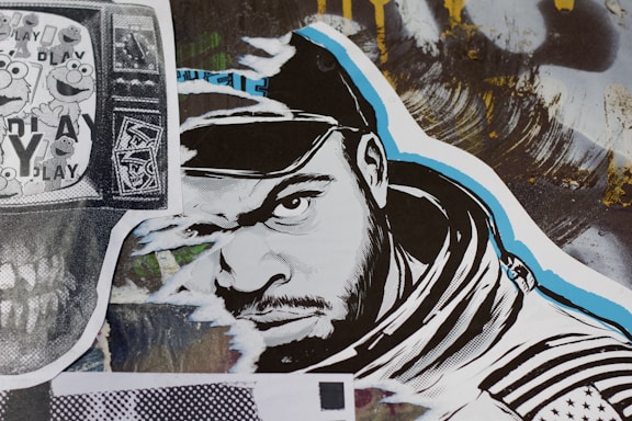 A stylized street art collage features a monochrome illustration of a man’s face wearing a hood. The artwork incorporates bold black and white lines with blue accents. To the left, a black and white print displaying cartoon characters overlaid on a TV screen adds a nostalgic element. A variety of textures and abstract backgrounds are present, contributing to a dynamic urban aesthetic.